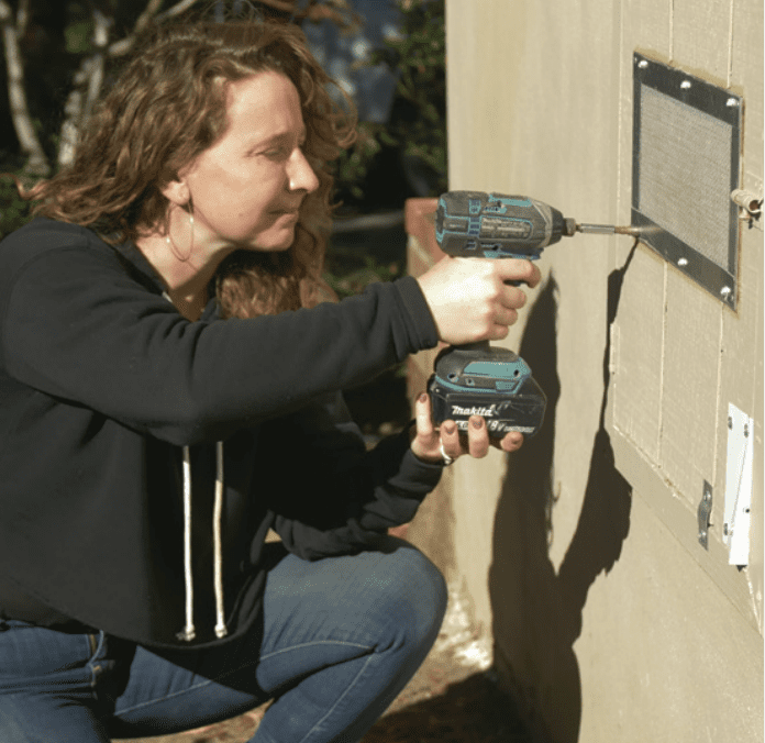 woman installing vent